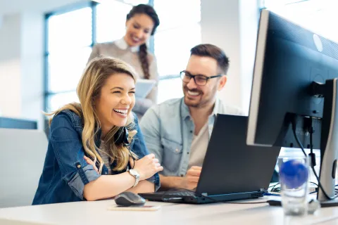 a few people working at a computer
