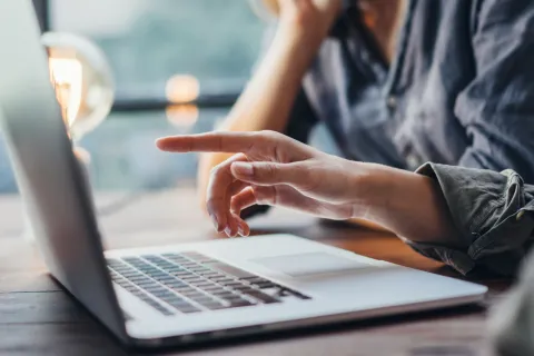 a man and a woman working on a laptop