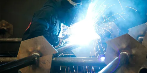 a person welding with sparks