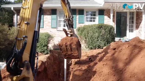 a house that has a pile of dirt in front of it