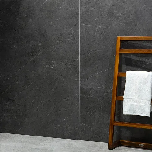 Wooden towel rack with a white towel against dark gray marble wall and light gray floor tiles.