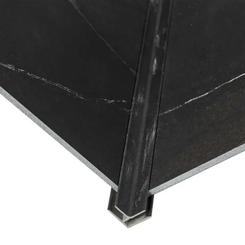 Close-up of black tile corner with metal edge trim protecting the tile edges for durability and finish.