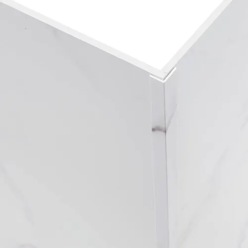 Close-up of a white marble corner with polished silver metal trim edge on the side of a surface.