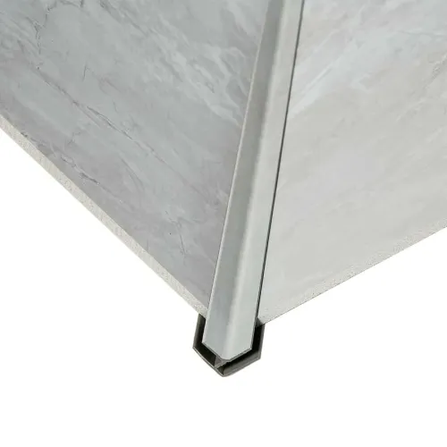 Close-up of a gray tile corner featuring a metal trim edge for protection and a polished finish.