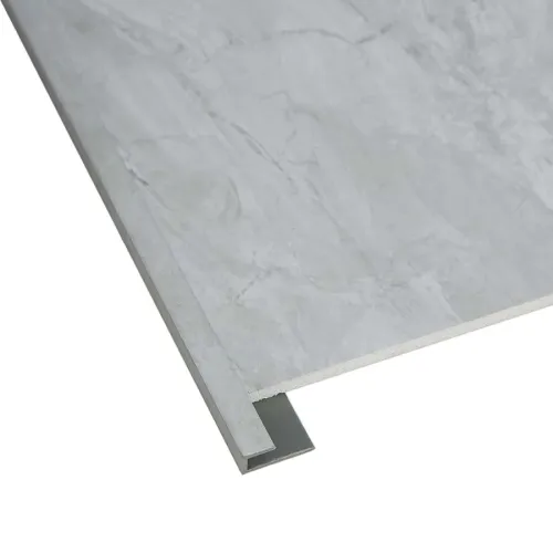 Close-up of a gray marble-textured tile with a metal T-shaped edge trim for flooring or wall installation.