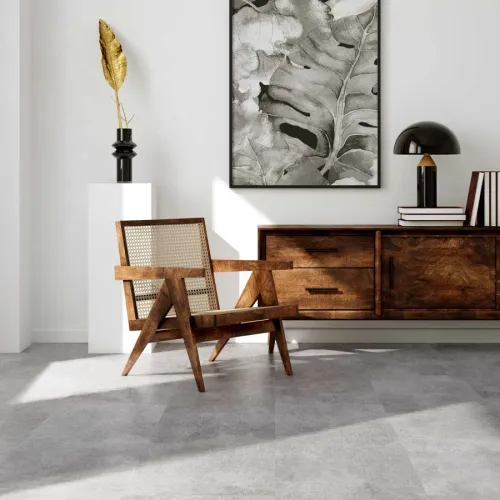 Modern living space with wooden chair, sideboard, black lamp, abstract leaf art, and decorative gold vase on pedestal.