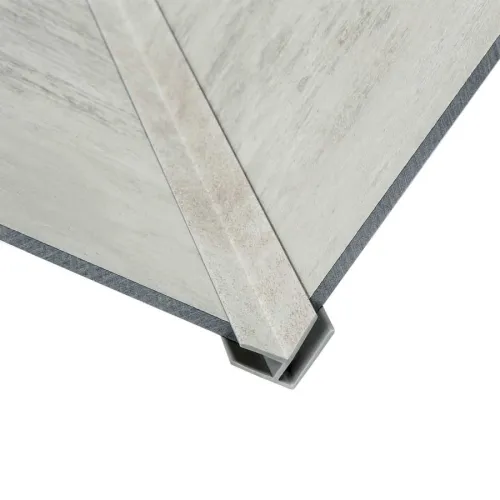 Close-up of concrete corner panels joined with a metal channel bracket on white background