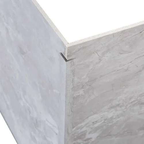 Close-up of an L-shaped metal bracket securing two marble-patterned panels at a corner joint.