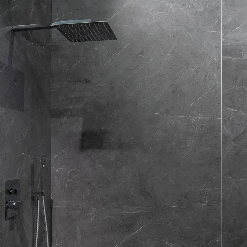 Modern bathroom shower with large square rainfall showerhead and dark gray marble wall tiles