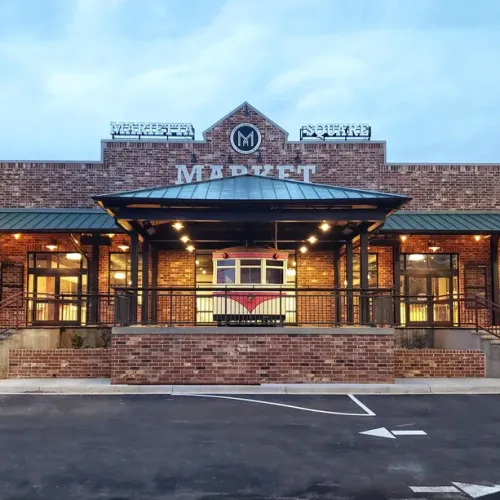 a building with a brick wall and a brick walkway