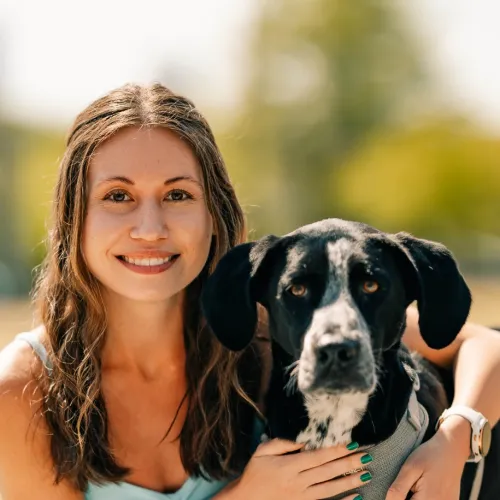 a woman holding a dog