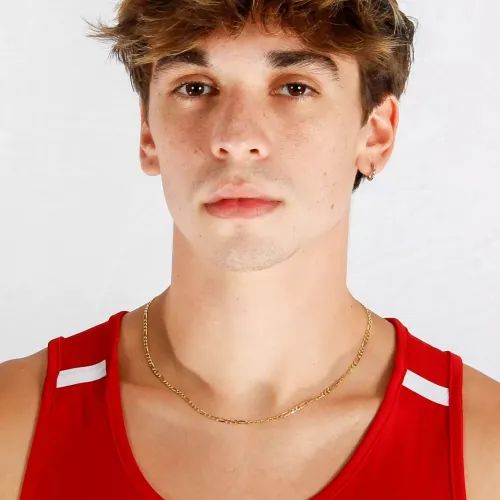Close-up of young man with brown hair wearing a red Adidas tank top and gold chain necklace against white background