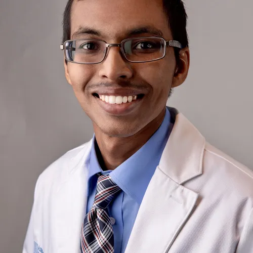 a man wearing glasses and a tie