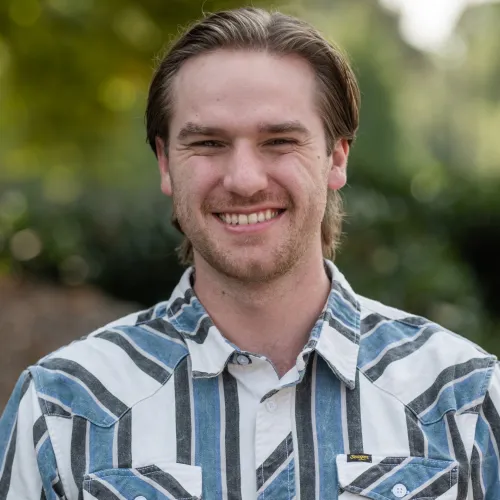 a man with a beard smiling