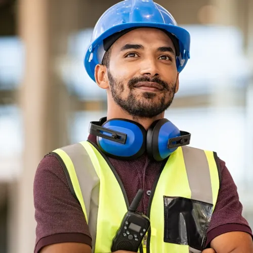 a man wearing a hard hat and safety vest
