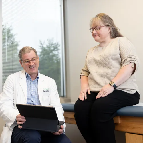 a doctor consulting with a patient at OrthoSouth Briarcrest