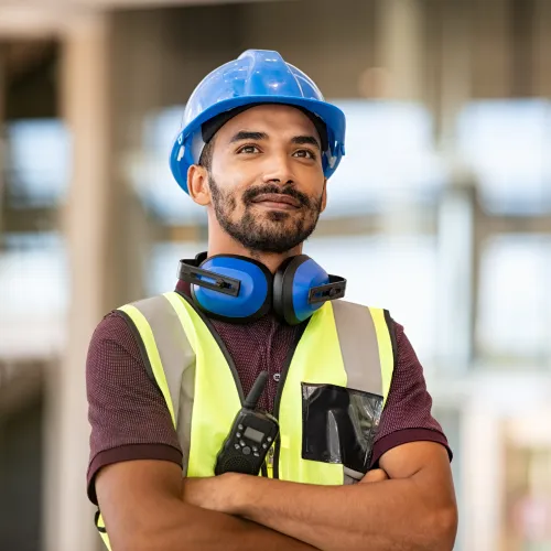 a man wearing a hard hat and safety vest