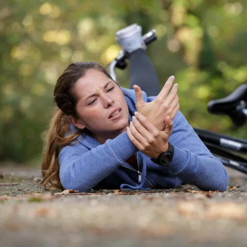 a person lying on the ground with the hands up