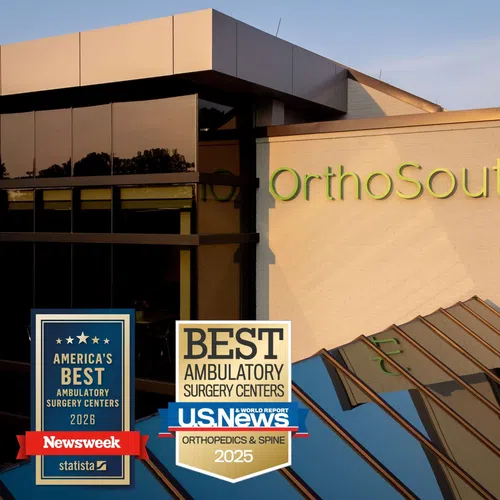 OrthoSouth building with 2025 and 2026 awards for best ambulatory surgery centers displayed on the exterior.