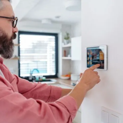 homeowner using his thermostat