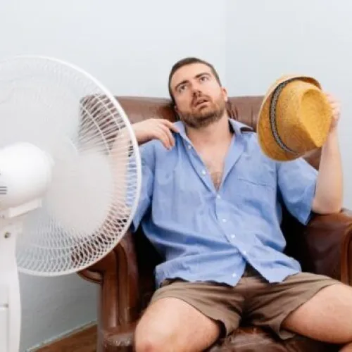 Man Sweating Because He Has No Air Conditioner