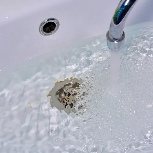Water filling up in a slow draining sink