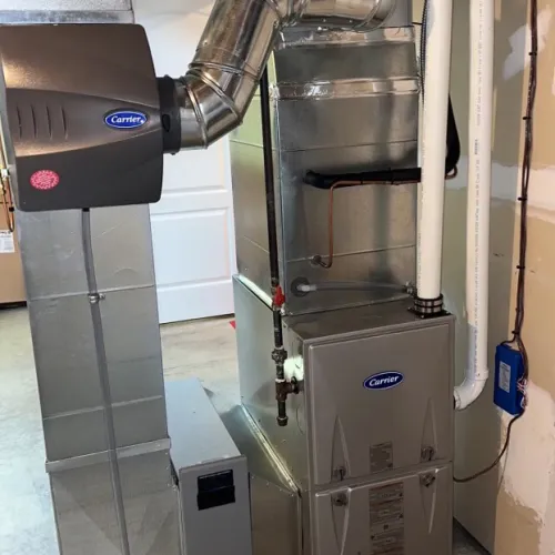 Residential Carrier HVAC furnace system with ductwork and vent pipes installed in basement