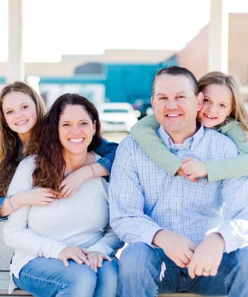 a group of people sitting together smiling