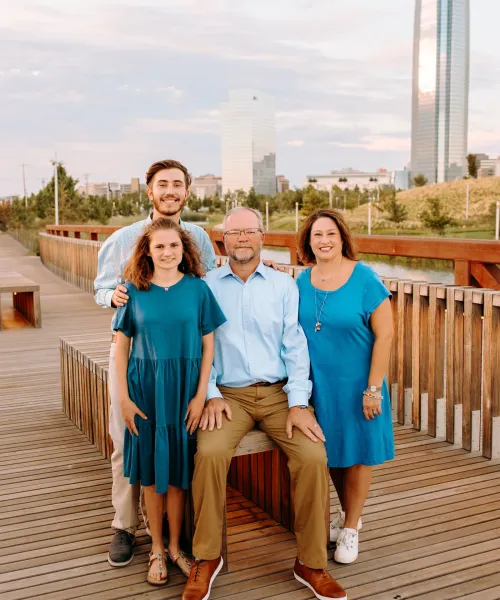 a group of people posing for a photo on a deck
