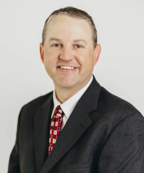 a man in a suit smiling