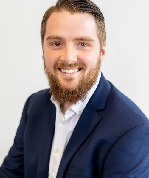 a man with a beard smiling