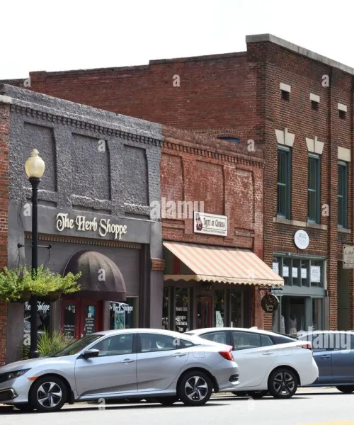 cars parked in front of a brick building