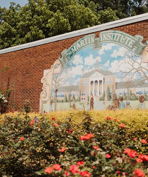 a large brick archway with flowers in front of it