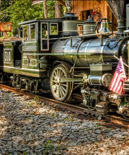 a train traveling down a dirt road