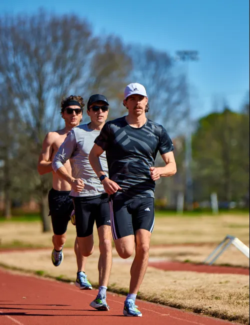 a group of people running on a track