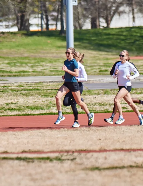 a group of people running on a track