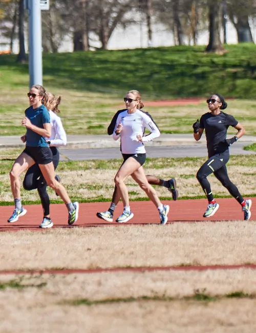 a group of people running on a track