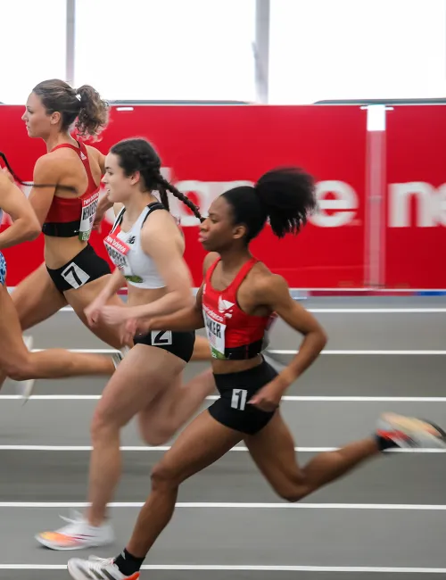 a group of women running on a track