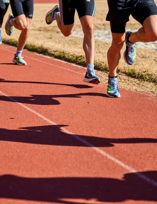 a group of people running on a track