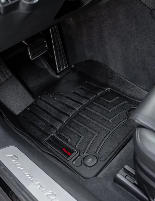 Black WeatherTech floor liner fitted in a Porsche Panamera Turbo driver's side footwell with pedals visible.
