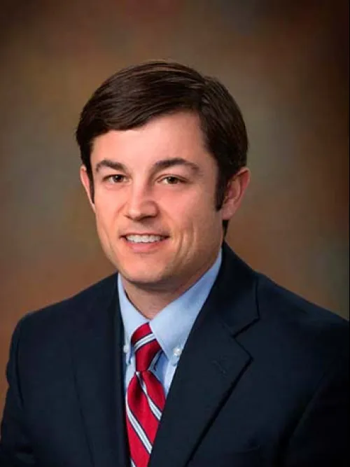 a man in a suit smiling