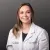 Smiling female healthcare professional in white coat with Advanced Urology logo on gray background