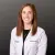 Smiling female healthcare professional wearing a white lab coat with name and Advanced Urology logo on gray background