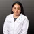 Female healthcare professional in white lab coat with Advanced Urology logo on gray background smiling