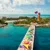Aerial view of a colorful pier leading to a tropical island water park with blue ocean and clear skies at perfect day at cococay.