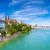 Panoramic view of Basel city with Rhine river, historic buildings, and blue sky on a sunny day.