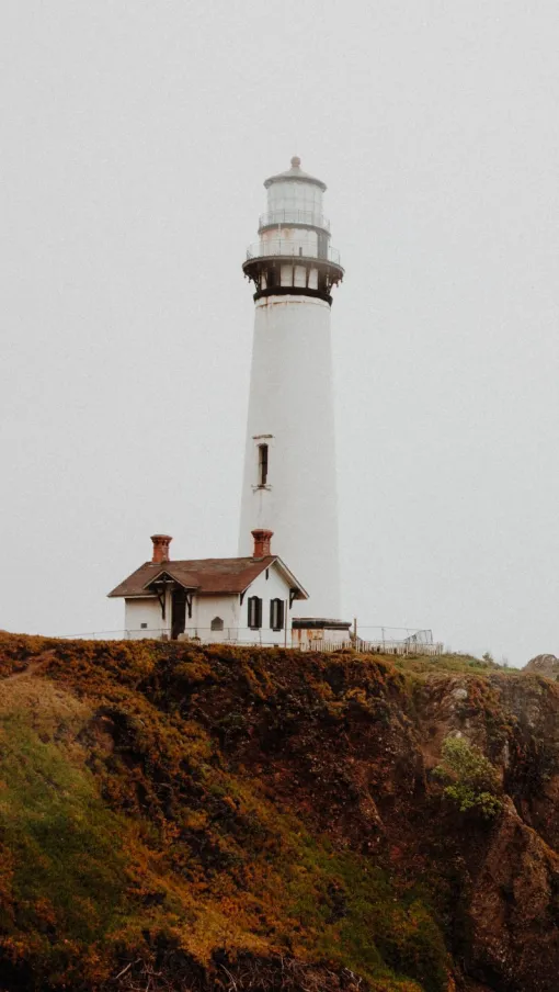 a lighthouse on a rocky hill