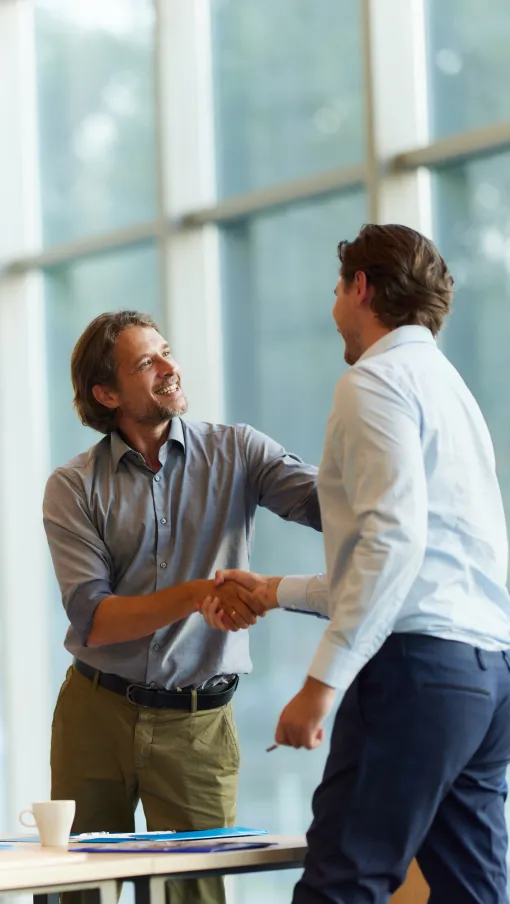 a person shaking hands with another man