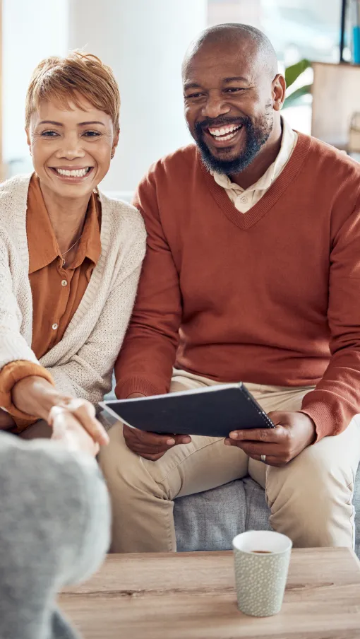 a man and a woman looking at a tablet