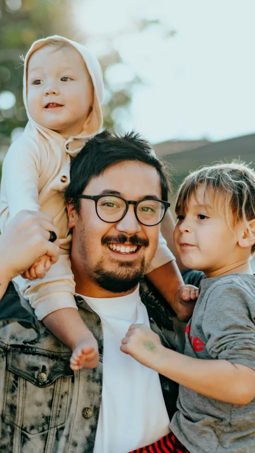 a person holding a couple of children